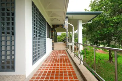 a walkway outside of a building with a gate at Blue Canyon Golf and Country Club Villa 97 in Ban Muang Mai (1)