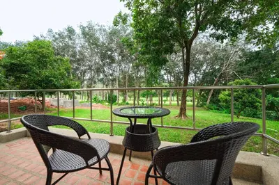 a patio with three chairs and a table and a table at Blue Canyon Golf and Country Club Villa 97 in Ban Muang Mai (1)