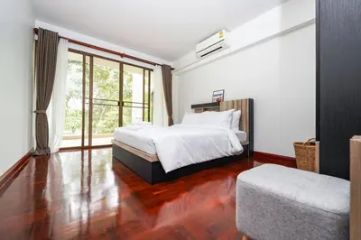 a bedroom with a bed and a large window at Blue Canyon Golf and Country Club Villa 97 in Ban Muang Mai (1)