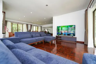 a living room with blue couches and a flat screen tv at Blue Canyon Golf and Country Club Villa 97 in Ban Muang Mai (1)