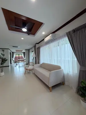 a living room with a white couch and a large window at Cozy Siray Phuket 3-Floor Seaview Family Home in Ban Lo Ti Pa (1)