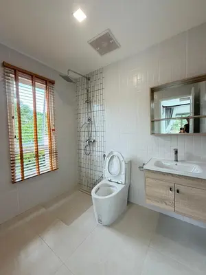 a bathroom with a toilet and a sink at Cozy Siray Phuket 3-Floor Seaview Family Home in Ban Lo Ti Pa (1)