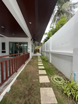 a hallway of a house with a hose at Cozy Siray Phuket 3-Floor Seaview Family Home in Ban Lo Ti Pa (1)