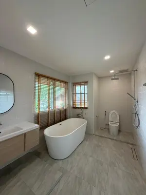 a large white bathroom with a tub and a toilet at Cozy Siray Phuket 3-Floor Seaview Family Home in Ban Lo Ti Pa (1)
