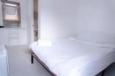 a white bed in a room with a window at xx Bao Patong Beach - Phuket Island in Patong Beach