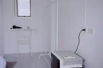 a white room with a bed and a mirror at xx Bao Patong Beach - Phuket Island in Patong Beach