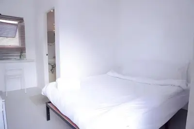 a white bed in a room with a window at xx Bao Patong Beach - Phuket Island in Patong Beach
