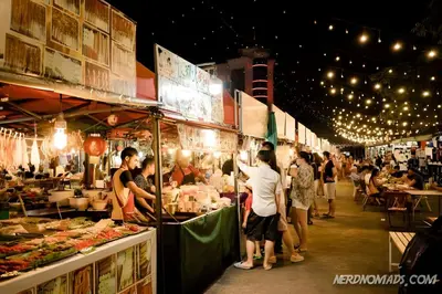 a group of people standing around a market with food at xx Bao Patong Beach - Phuket Island in Patong Beach