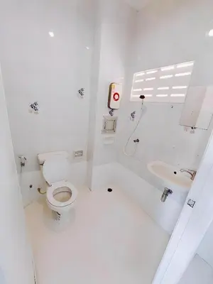 a white bathroom with a toilet and a sink at xx Bao Patong Beach - Phuket Island in Patong Beach