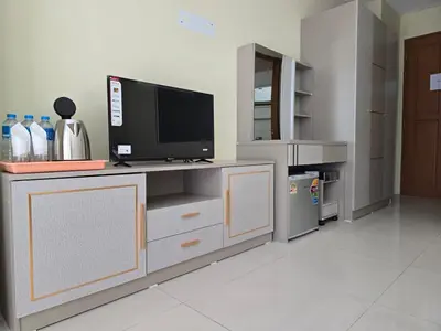 a living room with a tv on a counter at Blue Sapphire Hotel in Patong Beach