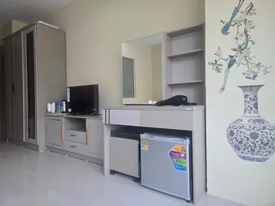 a kitchen with a counter and a vase on the wall at Blue Sapphire Hotel in Patong Beach