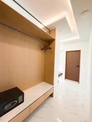 a room with a tv on a shelf and a door at Laoteng Boutique Hotel in Phuket Town
