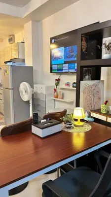 a kitchen with a desk with a lamp and a refrigerator at 209 Patong loft condominium in Patong Beach