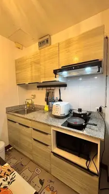 a kitchen with a counter with a stove and a microwave at 209 Patong loft condominium in Patong Beach
