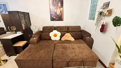 a teddy bear sitting on a couch in a living room at 209 Patong loft condominium in Patong Beach