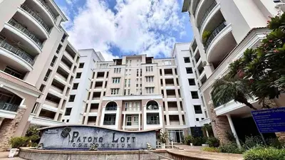 a large white building with a sign in front of it at 209 Patong loft condominium in Patong Beach
