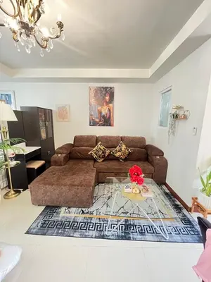 a living room with a brown couch and a table at 209 Patong loft condominium in Patong Beach