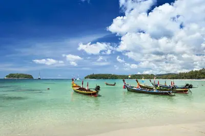 three boats sitting in the water on a beach at 3-Story Pool Villa Near Kata Beach - UTK 4 in Kata Beach