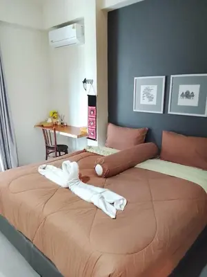 a large bed with two white towels on it at Arch Club in Patong Beach