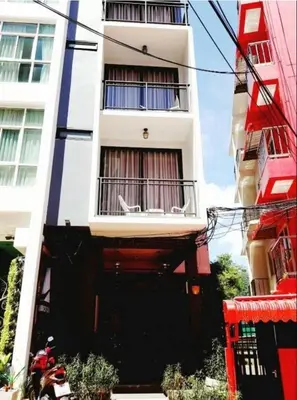 a building with a motorcycle parked in front of it at Arch Club in Patong Beach