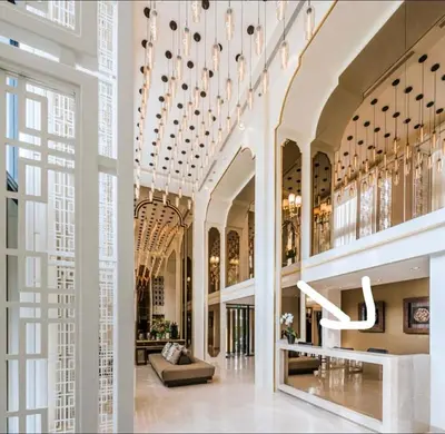 a large building with a lobby with chandeliers at Elegant Stay with 360 degree Panoramic Rooftop Pool in Ban Sam Kong