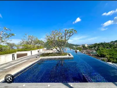 a pool on the roof of a building with a tree at Elegant Stay with 360 degree Panoramic Rooftop Pool in Ban Sam Kong