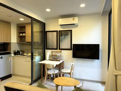 a kitchen and dining room with a table and chairs at Private apartment at Skypark in Laguna by Lofty in Laguna Phuket
