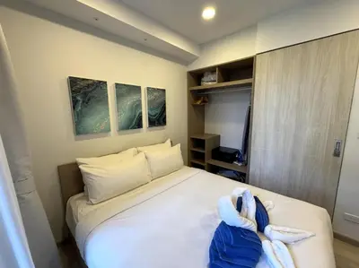 a bedroom with a bed with towels on it at Private apartment at Skypark in Laguna by Lofty in Laguna Phuket