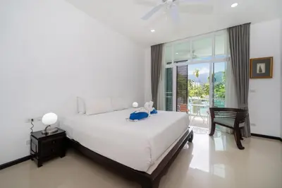 a bedroom with a large white bed and a window at Tropical retreat-pool villa at Oxygen Bangtao in Ban Thalat Choeng Thale