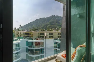 a view from a window of a pool and a mountain at 2BR Penthouse with Private Pool Rooftop Absolute Twin Sands 5404 in Patong Beach