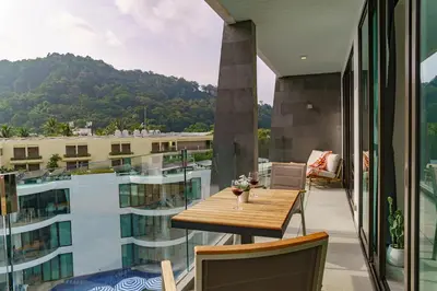 a balcony with a table and a view of a building at 2BR Penthouse with Private Pool Rooftop Absolute Twin Sands 5404 in Patong Beach