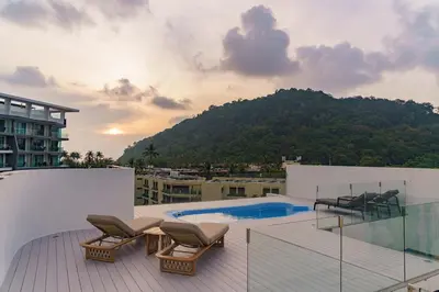 a balcony with chairs and a swimming pool on a building at 2BR Penthouse with Private Pool Rooftop Absolute Twin Sands 5404 in Patong Beach