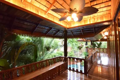 a wooden porch with a ceiling fan and a deck at Villa Habeebee in Ao Nang Beach