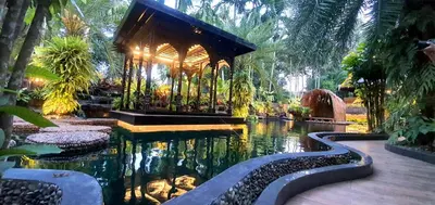 a garden with a pond in the middle of it at Villa Habeebee in Ao Nang Beach