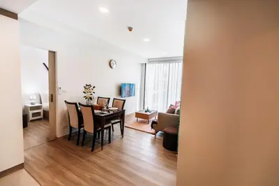 a dining room and living room with a table and chairs at Sky Park Golg View 2BR Bang Tao Laguna in Laguna Phuket