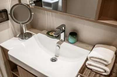 a bathroom sink with a mirror and a faucet at Sky Park Golg View 2BR Bang Tao Laguna in Laguna Phuket