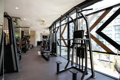 a gym with several tread machines and windows at Modern Residence Tropics CTG-L709 with Medical and Wellness Center in Kamala Beach