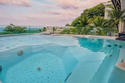 a large swimming pool with a view of the ocean at The Seaview Kata in Kata Beach
