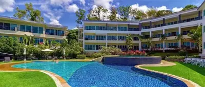 a large apartment building with a large swimming pool at Modern 2BR Condo at Karon Butterfly Phuket in Karon Beach