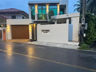 a house with a not much yard sign on a wall at Villa Maria Luxury in Kamala Beach