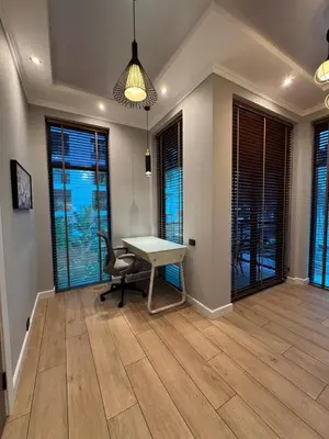 a room with a table and a chair and windows at Villa Maria Luxury in Kamala Beach