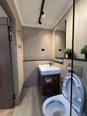 a bathroom with a white toilet and a sink at Villa Maria Luxury in Kamala Beach