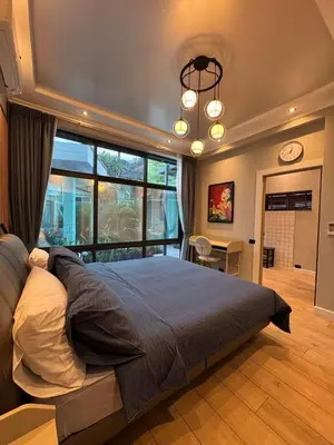 a bedroom with a large bed and a large window at Villa Maria Luxury in Kamala Beach