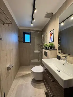 a bathroom with a white toilet and a sink at Villa Maria Luxury in Kamala Beach