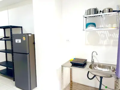 a kitchen with a refrigerator next to a sink at Patong Canal Villa 103 in Patong Beach