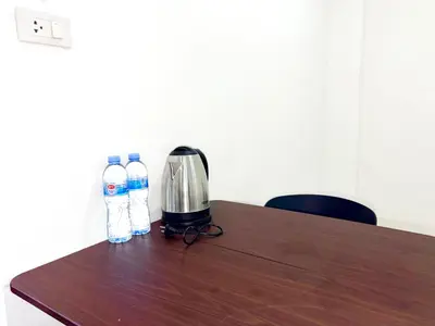a table with two bottles of water and a coffee maker at Patong Canal Villa 103 in Patong Beach
