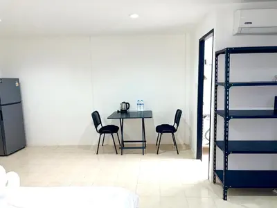 a dining room with a table and two chairs at Patong Canal Villa 304 in Patong Beach