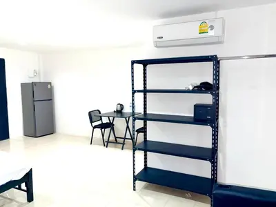 a shelf in a room with a table and a refrigerator at Patong Canal Villa 304 in Patong Beach