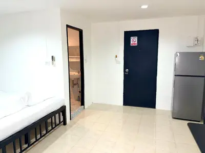 a room with a blue door and a refrigerator at Patong Canal Villa 304 in Patong Beach