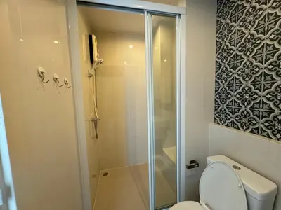 a bathroom with a shower and a toilet at The Base Height Phuket in Phuket Town